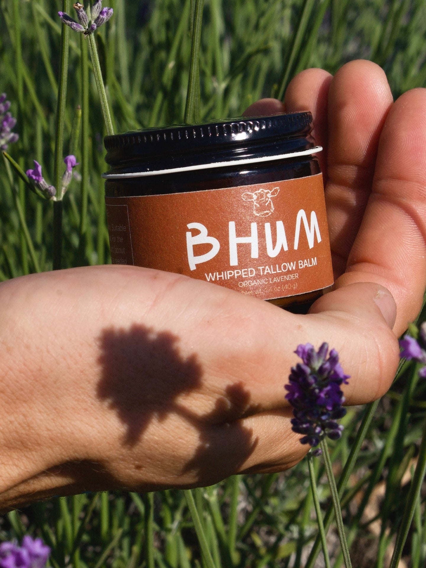 BHUM Whipped Tallow Balm Lavender - hand holding jar with lavender